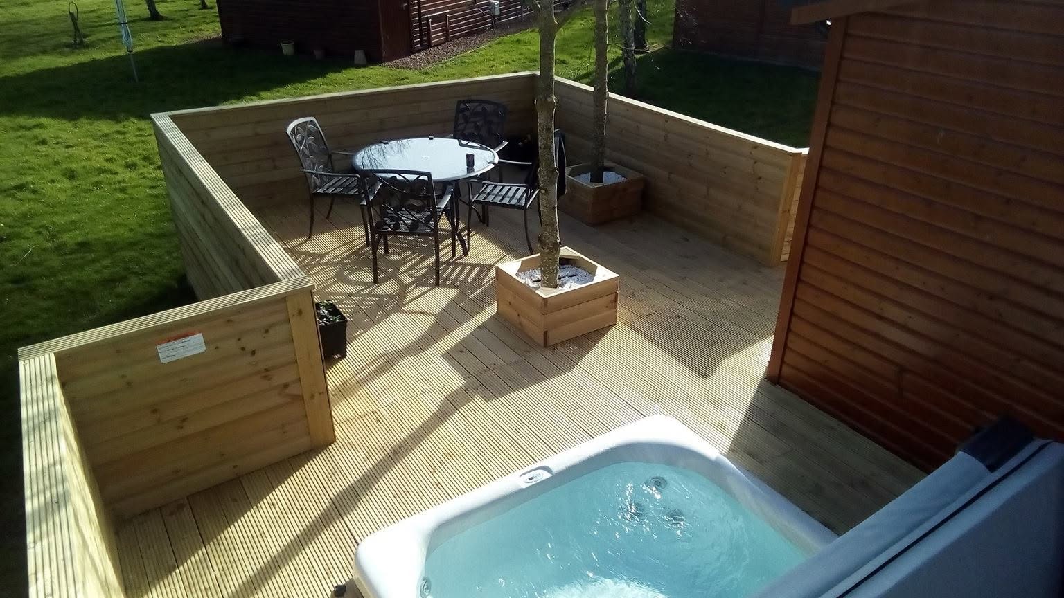 Raised holiday lodge decking with timber balustrade and outdoor seating